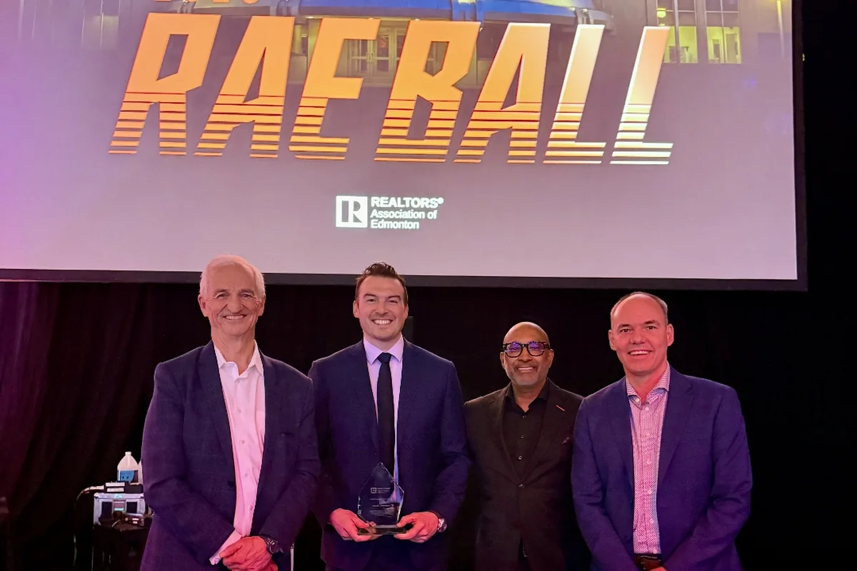 Jacob Johnson accepting the 2025 Rookie of the Year award at the REALTORS Association of Edmonton ball