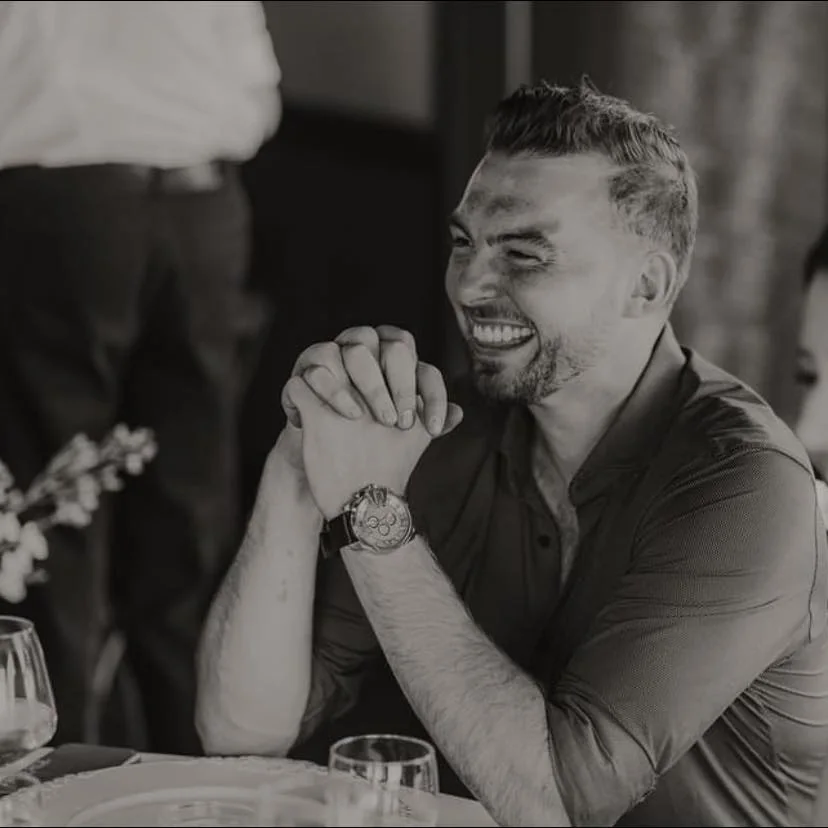 Jacob Johnson laughing at a table during a dinner in Edmonton