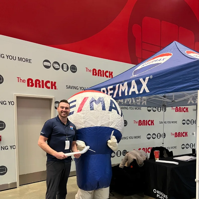 Jacob Johnson at a community event with the RE/MAX balloon mascot