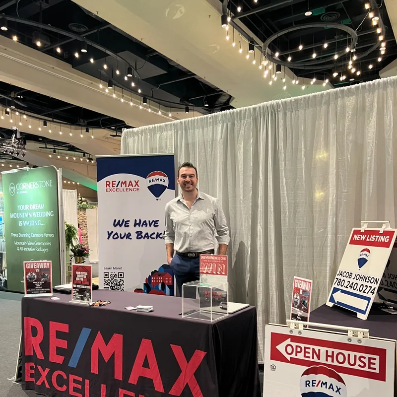 Jacob Johnson at the RE/MAX Excellence booth with his own open house sign
